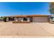 Inviting single-story home featuring a desert-style landscaped front yard with a two-car garage at 662 W Laguna Azul Ave, Mesa, AZ 85210
