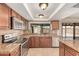 The kitchen features granite counters, stainless appliances, and view of fenced pool at 662 W Laguna Azul Ave, Mesa, AZ 85210