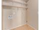 Dedicated laundry room with overhead shelving and connections ready for a washer and dryer at 662 W Laguna Azul Ave, Mesa, AZ 85210