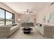 Spacious living room with modern furniture, a ceiling fan, and large windows at 662 W Laguna Azul Ave, Mesa, AZ 85210