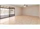 This living room boasts tile floors and sliding doors to a covered patio and pool at 662 W Laguna Azul Ave, Mesa, AZ 85210