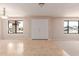 Bright living room featuring neutral walls, tiled floors, modern lighting, and large windows at 662 W Laguna Azul Ave, Mesa, AZ 85210