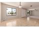 Open living room with tile and carpet flooring, large window, and modern lighting fixture at 662 W Laguna Azul Ave, Mesa, AZ 85210