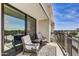 Relaxing balcony featuring two chairs, a small table, and stunning city views from a modern apartment at 6803 E Main St # 5506, Scottsdale, AZ 85251