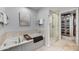Bright bathroom featuring a soaking tub, separate shower, and a convenient walk-in closet at 6803 E Main St # 5506, Scottsdale, AZ 85251