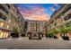 Exterior courtyard with fountain and manicured landscaping under a colorful sunset at 6803 E Main St # 5506, Scottsdale, AZ 85251