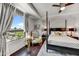 Elegant main bedroom boasting a four-poster bed, stylish chair, and a picturesque window view at 6803 E Main St # 5506, Scottsdale, AZ 85251