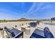 This rooftop lounge with a fire pit, plush seating, and views of the city and mountains offers a relaxing retreat at 6803 E Main St # 5506, Scottsdale, AZ 85251