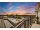 Scenic sunset view from a balcony overlooking charming rooftops and distant mountains at 6803 E Main St # 5506, Scottsdale, AZ 85251