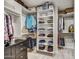Organized walk-in closet with custom shelving and ample storage space and dresser, for a tidy wardrobe at 6803 E Main St # 5506, Scottsdale, AZ 85251