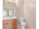 Half bathroom featuring vanity with storage, toilet, mirror, neutral wall color, and tile flooring at 7418 S 25Th Ln, Phoenix, AZ 85041