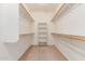 Spacious walk-in closet features neutral carpet, shelves, and clothing rods for ample storage space at 7418 S 25Th Ln, Phoenix, AZ 85041