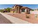 Attractive two-story home with a tile roof, stone accents, desert landscaping, and a spacious three-car garage at 7418 S 25Th Ln, Phoenix, AZ 85041