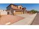 Beautiful two-story home with a three-car garage, tile roof, and desert landscaping for low maintenance at 7418 S 25Th Ln, Phoenix, AZ 85041