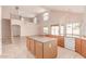 Open concept kitchen with granite countertops, tiled floors, an island, and stainless steel appliances at 7418 S 25Th Ln, Phoenix, AZ 85041
