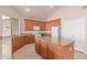 Spacious kitchen features wooden cabinetry, granite countertops, a center island, and modern appliances at 7418 S 25Th Ln, Phoenix, AZ 85041
