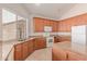 Well-lit kitchen featuring granite countertops, wood cabinets, and tiled flooring with a large window at 7418 S 25Th Ln, Phoenix, AZ 85041