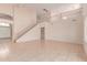 Open living room showcasing high ceilings, tiled floors, staircase, and natural light from windows at 7418 S 25Th Ln, Phoenix, AZ 85041