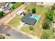 Aerial view of home with an in-ground pool, spacious grass area, a shed, and a detached garage at 802 E Harwell Rd, Gilbert, AZ 85234