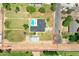 Expansive property featuring a backyard pool, large grassy area, and a charming home nestled among mature trees at 802 E Harwell Rd, Gilbert, AZ 85234