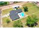Aerial view of home with inground pool, grassy areas, mature trees, and shed in backyard at 802 E Harwell Rd, Gilbert, AZ 85234