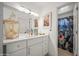 Elegant bathroom featuring white cabinets, a large mirror, and a decorative lantern with sea shells at 802 E Harwell Rd, Gilbert, AZ 85234