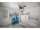 Bright ' bedroom with a white bed frame and a blue doll house against a sunny window at 802 E Harwell Rd, Gilbert, AZ 85234
