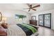 Comfortable bedroom with wood floors, a ceiling fan, and backyard access at 802 E Harwell Rd, Gilbert, AZ 85234
