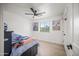 Cozy bedroom with a ceiling fan, window view, and a fun basketball hoop for added entertainment at 802 E Harwell Rd, Gilbert, AZ 85234