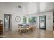 Bright dining room with views of the outdoor pool, featuring a large table with seating for ten at 802 E Harwell Rd, Gilbert, AZ 85234