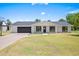 Charming single-story home featuring a lush green lawn and modern exterior finishes at 802 E Harwell Rd, Gilbert, AZ 85234