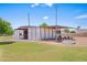 Outdoor horse stall and playground with green grass under a blue sky at 802 E Harwell Rd, Gilbert, AZ 85234