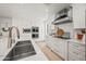 Modern kitchen featuring stainless appliances, white cabinetry, and double sink at 802 E Harwell Rd, Gilbert, AZ 85234