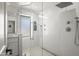 Modern shower with glass doors, white tiling, and multiple shower heads at 802 E Harwell Rd, Gilbert, AZ 85234