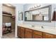 Bright bathroom with a single sink vanity, a large mirror and a walk-in closet at 850 S River Dr # 2065, Tempe, AZ 85281