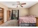 This bedroom boasts plush carpet, a ceiling fan, and a glass slider leading to an outdoor space at 850 S River Dr # 2065, Tempe, AZ 85281