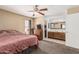 Inviting bedroom with plush carpet, a ceiling fan, and an en-suite bathroom, offering comfort and convenience at 850 S River Dr # 2065, Tempe, AZ 85281