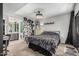 Spacious bedroom with plush carpet, a ceiling fan, and an attached bathroom entrance for added convenience at 850 S River Dr # 2065, Tempe, AZ 85281