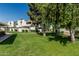Well-maintained green spaces with mature trees surround the home's exteriors at 850 S River Dr # 2065, Tempe, AZ 85281