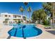 Sparkling blue community pool surrounded by palm trees and lounge chairs at 850 S River Dr # 2065, Tempe, AZ 85281