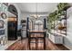 Bright dining room with wood floors, black accents, and lots of natural light from the large arched windows at 850 S River Dr # 2065, Tempe, AZ 85281