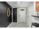 Stylish entryway featuring patterned tile floors and a decorative oval mirror at 850 S River Dr # 2065, Tempe, AZ 85281