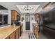 This kitchen offers wood cabinets, a stainless sink, and unique lighting, perfect for a modern living space at 850 S River Dr # 2065, Tempe, AZ 85281