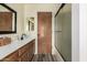 Bathroom featuring a shower with glass doors, and wood cabinets at 930 N Sandal Cir, Mesa, AZ 85205