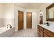 Bathroom boasts tile floors, vanity with sink, and a separate bathtub area at 930 N Sandal Cir, Mesa, AZ 85205