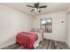 Cozy bedroom with ceiling fan and view to backyard at 930 N Sandal Cir, Mesa, AZ 85205