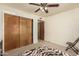 Bedroom features a ceiling fan, and ample closet space at 930 N Sandal Cir, Mesa, AZ 85205