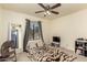 Bedroom features neutral carpeting, ceiling fan, and view to backyard at 930 N Sandal Cir, Mesa, AZ 85205