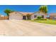Charming single-story home featuring a spacious driveway and a well-maintained lawn at 930 N Sandal Cir, Mesa, AZ 85205