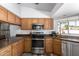 Charming kitchen features stainless steel appliances, granite counters, and ample cabinets at 930 N Sandal Cir, Mesa, AZ 85205